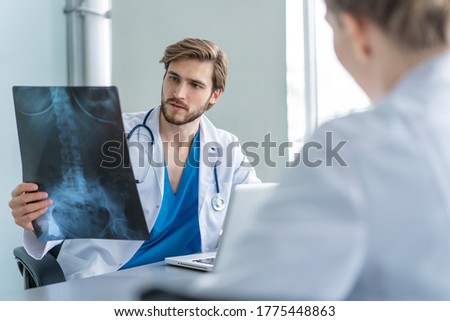 Doctors analyzing an x-ray in a meting