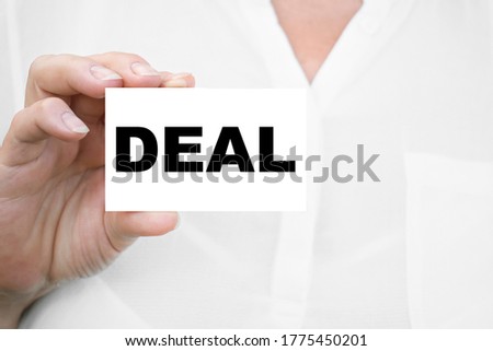 DEAL girl in a white shirt shows a business card