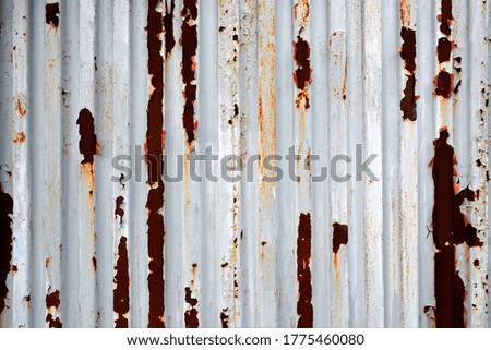 Paint peeling, rusted iron wall
