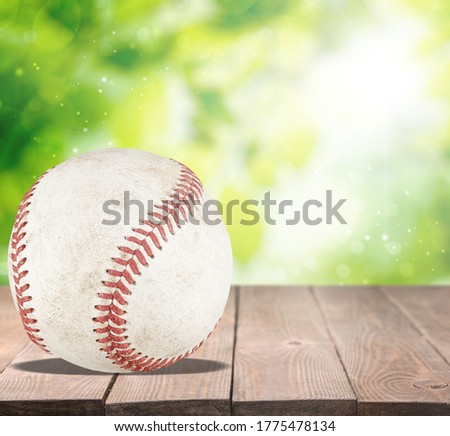 Baseball ball with seams on the wooden desk