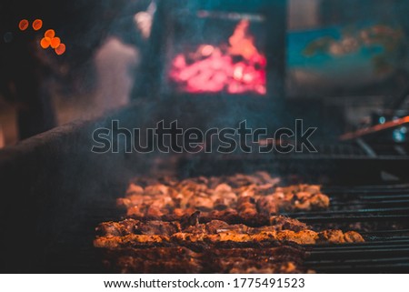 Beef tikka boti on the grill with flames