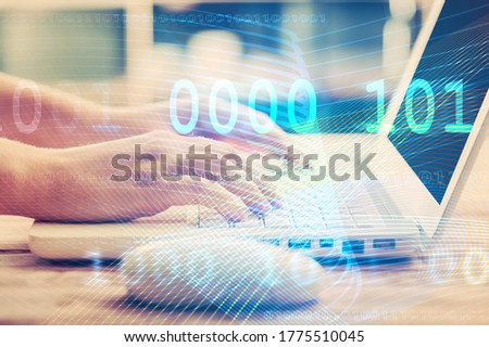 Hands of human typing on a laptop with digital interface and infographics.