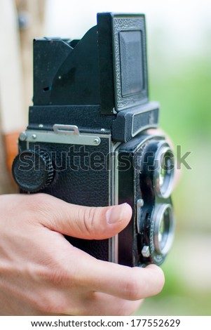 twin-lens camera in hand