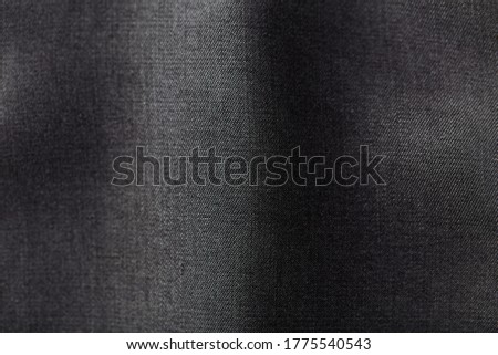 Close up of dark tencel fabric. Tencel   (Lyocell) is a form of rayon that consists of cellulose fibre made from dissolving pulp. Top view. Copy space. 
