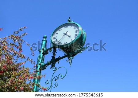 Blue Art Nouveau clock with tree with red flowers in the city of Frutillar, Chile