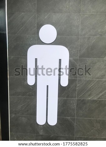Restroom sign on a toilet door,on wood background.Toilet sign