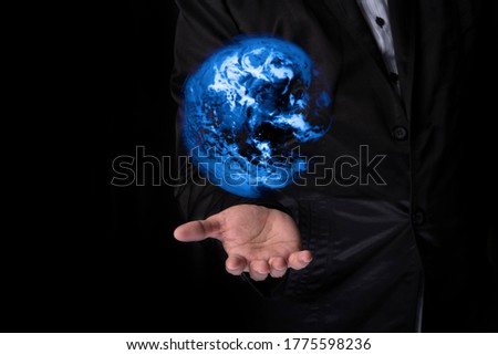 The businessman opens his hand up to hold the graphic earth, Element of this image furnished by Nasa