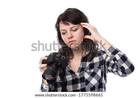 Young female freelance professional photographer or art student or photojournalist on a white background holding a camera. She is feeling sick or unwell Royalty-Free Stock Photo #1775598665