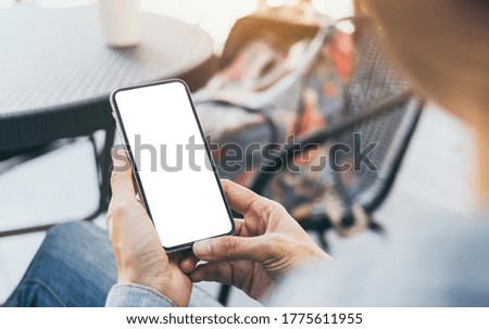 cell phone mockup image blank white screen.woman hand holding texting using mobile on desk at coffee shop.background empty space for advertise.work people contact marketing business,technology 