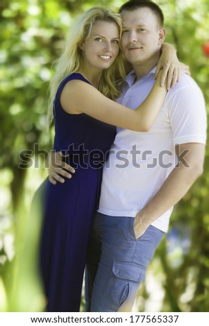 young loving couple on natural green background