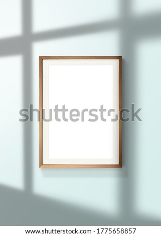 vertical poster mock up with wood frame on wall and window shadow with clipping path.