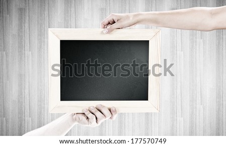 Close up of human hands holding blank frame