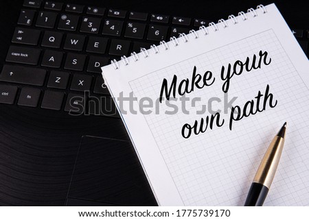 Make your own path - written on a notebook with a pen. High quality photo