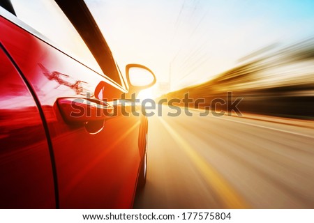 A car driving on a motorway at high speeds, overtaking other cars Royalty-Free Stock Photo #177575804