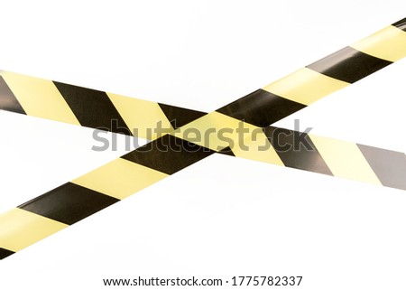 Black and yellow restrictive tape on a white background. The tape is crossed, restriction