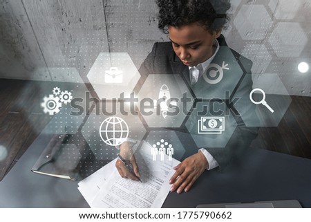 A woman signs contract and business icons symbol hologram. Double exposure.