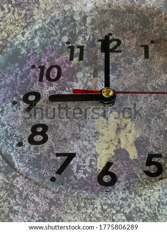 The fantasy background of the clock overlapping with flowers.