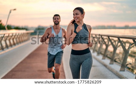 Couple doing sport together on the street. Morning run