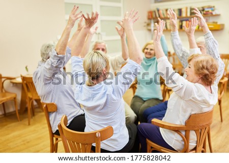 Group of seniors in old people's home doing sitting exercises or exercise therapy exercise Royalty-Free Stock Photo #1775828042