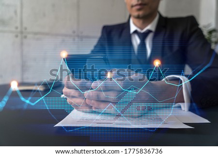 Analyst in office working with Smartphone, Data forecast graph hologram to analyze market behavior, typing phone. Double exposure. Royalty-Free Stock Photo #1775836736