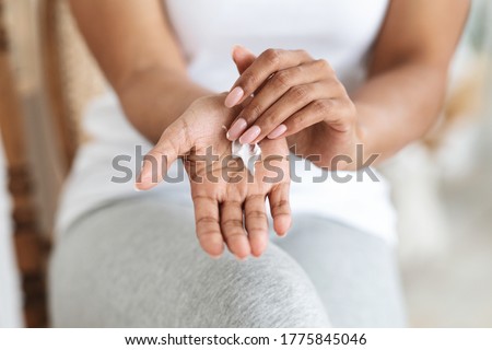 Best Hand Cream For Dry Skin. Unrecognizable Black Woman Rubbing Moisturizing Lotion To Palm, Cropped Image, Closeup Royalty-Free Stock Photo #1775845046