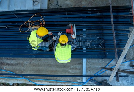 High angle view of construction worker wearing safety hats are working in construction site.