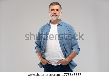 Portrait of smiling mature man standing on white background. Royalty-Free Stock Photo #1775868887