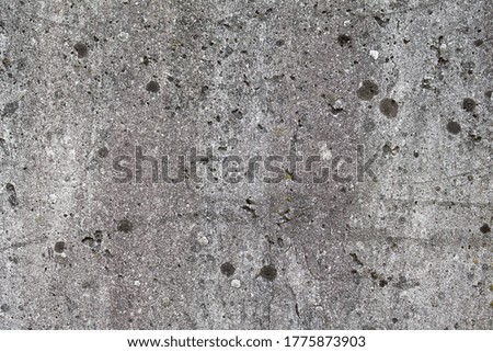 Texture of a dirty concrete wall with signs of age.