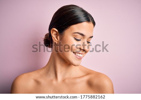 Close up of young beautiful woman with clear and pure skin. Perfect and clean skincare wearing natural makeup. Smiling happy looking fresh and healthy.
