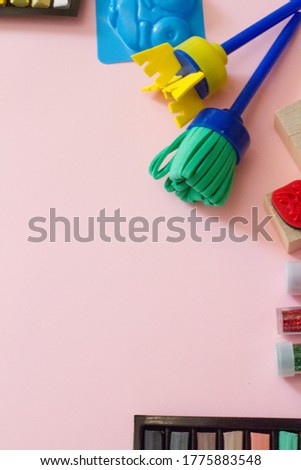 Flatley's Children. children's toys in a frame on a pink background. The concept of development and education of children, children's creativity and education in schools and kindergartens.