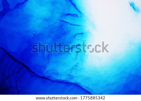 Blue Background. Blue ink texture with abstract washes and paint stains on the white paper background. Hand painted background. Blue ink background for design