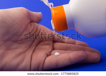 Sunblock Bottle on blue background. Health concepts and skin care
