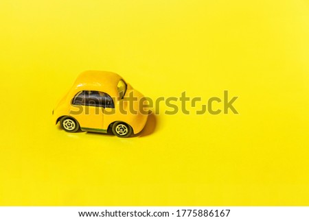Simply design yellow vintage retro toy car isolated on yellow colorful background. Automobile and transportation symbol. City traffic delivery concept. Copy space