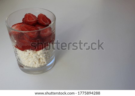 cooking Breakfast rustic fresh cottage cheese with fruit and strawberry berries in a glass quick snack of healthy food on a white background