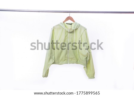 Green jacket with a zipper with a hood isolated on a white background. Windbreaker jacket. Casual style

