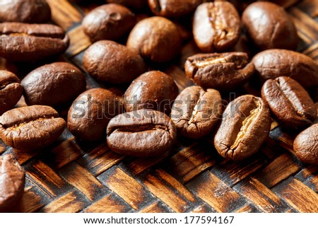 close up of fresh coffee beans on bamboo plate and  ready to brew delicious coffee