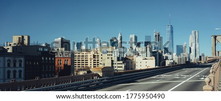 Image of an empty road at the Brooklyn Bridge in New York. Manhattan skyline in background