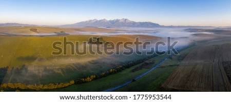 beautiful landscape with valleys, lakes and rivers in High Tatras in fog