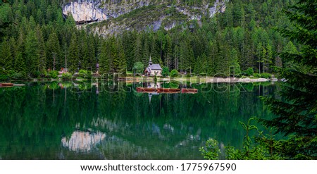 Braies Lake with forest on background. Colorful spring view of Italian Alps, Naturpark Fanes-Sennes-Prags, Dolomite, Italy, Europe. Traveling, ecological and photo tourism.