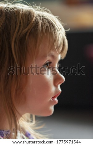 image of a child from profile while looking cartoon, note shallow depth of field