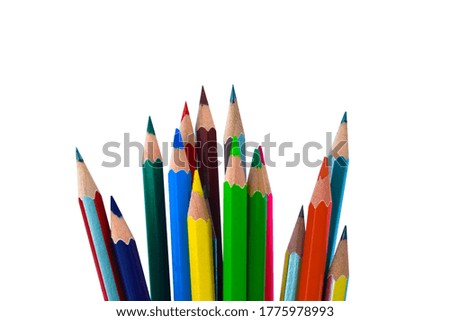 One huge pile of different colored wood pencil crayon placed on a white paper background