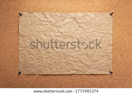 sheet of paper pinned at corkboard as background texture