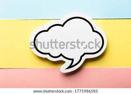 Blank speech bubble paper is isolated on the colorful background.