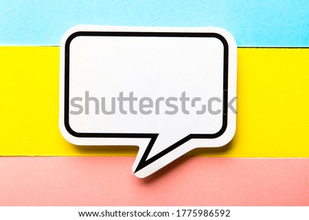 Blank speech bubble paper is isolated on the colorful background.