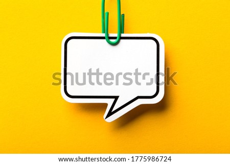 Blank speech bubble paper is isolated on the yellow background.