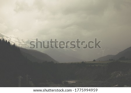 heavy raincloud covered the ground of a mountain valley, rain is coming Royalty-Free Stock Photo #1775994959