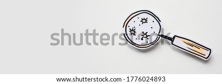 Magnifier and bacteria and virus cells on white