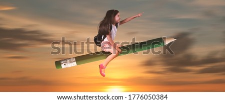 Back to school concept and little girl sitting on pencil is flying in the sky.