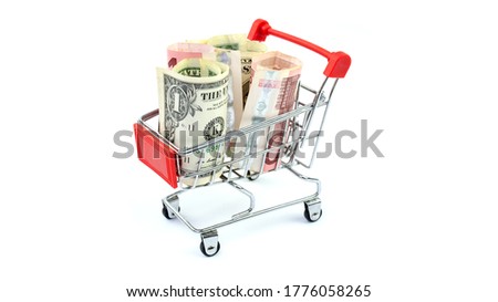 Shopping carts full of rolled banknotes. Shopping expenses, supermarket, finance and money concept. White background, horizontal closeup.