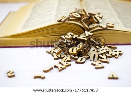 Letters and book on white background